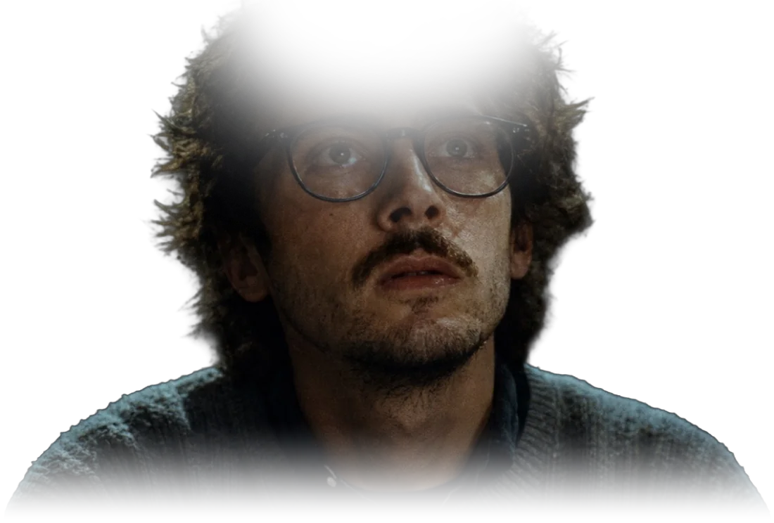 An editor lit by the screen, looking up at the moment he has just found.